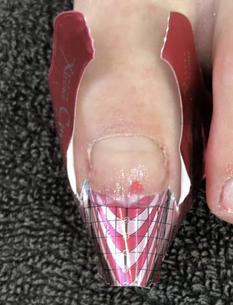 Step 4: Apply transparent pink L&P or Gel to the nail and bring out onto the form, not extending past where the skin ends.  Ensure you do not touch the skin or sidewalls when applying the product.