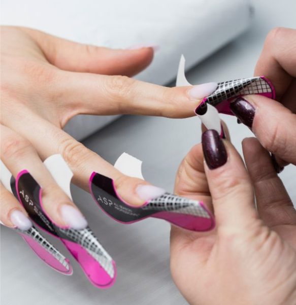STEP 1 To begin, use ASP’s pink Power Set Acrylic Powder to sculpt the nails into a medium-length olive shape.