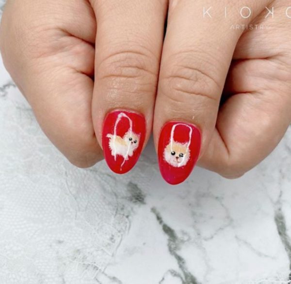 Jessica from @kiokoartistry upgraded this classic red manicure with Pomeranian puppies