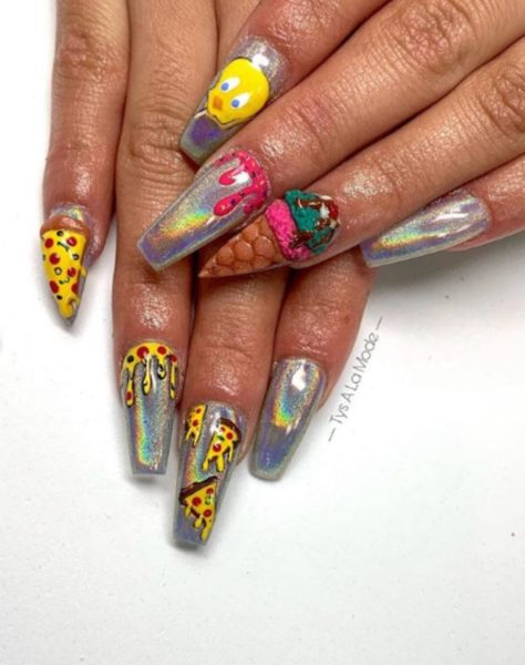 With a silver holographic base, this coffin set by Tys à la Mode is offset by one nail being filed into a stiletto shape to mimic the shape of a slice