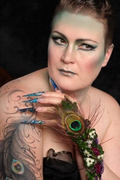 Tiia Puputti
"Love nature and birds. This theme was also choosen by models peacock tattoo. I love detailed nail art and freehand painting, so there is peacocks head painted with gels in one finger. These are gel nails."