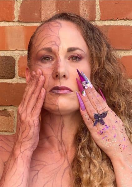 Carly Dorman
"This is me. I have chosen mental health as it’s something I have suffered with for many years the dark and the bright side suffering from many traumatic past events , the dark side showing the inner hidden pain and not wanting nails or any thing done feeling broken inside the hidden pain that isn’t clear for others to see the way mental health can effect our body to. The bright side having make up, hair and full nails done shining bright and standing proud. I have used the art of one stroke as find this so therapeutic for my mental health, roses are one of my favourite flowers which represents growth, the butterfly represents change, the crystals represent to keep shining bright. Using the nailchemy’s beautiful minds gel polish’s, acrylic and crystals from Crystal Parade. Model- make up- hair- nails - myself. Photography - My husband"