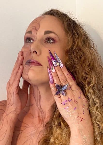 Carly Dorman
"This is me. I have chosen mental health as it’s something I have suffered with for many years the dark and the bright side suffering from many traumatic past events , the dark side showing the inner hidden pain and not wanting nails or any thing done feeling broken inside the hidden pain that isn’t clear for others to see the way mental health can effect our body to. The bright side having make up, hair and full nails done shining bright and standing proud. I have used the art of one stroke as find this so therapeutic for my mental health, roses are one of my favourite flowers which represents growth, the butterfly represents change, the crystals represent to keep shining bright. Using the nailchemy’s beautiful minds gel polish’s, acrylic and crystals from Crystal Parade. Model- make up- hair- nails - myself. Photography - My husband"