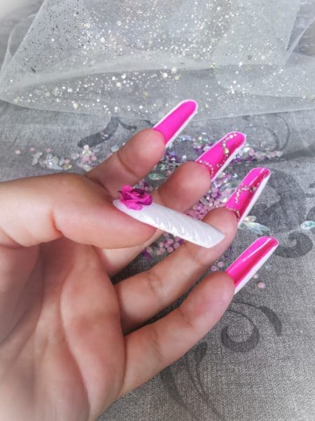 Candy Pap
"Working as a nail tech I often file the top of my nail or the decoration so I decided to decorate under the tip. This 2 tone nail represents my personality, can be pure like white with a rose or cheeky like pink with the diamonds at the same time."
