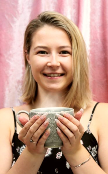 Sophie Gore
"In my photo I decided to stay true to myself and simply smile. I am not a model who knows how to pose for the perfect photo, I am a beauty therapist from Sheffield who is very passionate about the industry with the dream to grow my business by challenging myself. As you can see I'm never without a cup of tea in my hands and I believe this particular cup couldn't represent my style any better. The ring I'm wearing is one I wear everyday as it was given to my mother, the first time my father proposed to her. The bracelet I'm wearing has my nickname "Soph" ingrave into it as well as a diamond which represents my birth month. I also chose to go with opal nails as opal is too, a birthstone known to be associated with April. Finally my backdrop is my beauty room blanket."