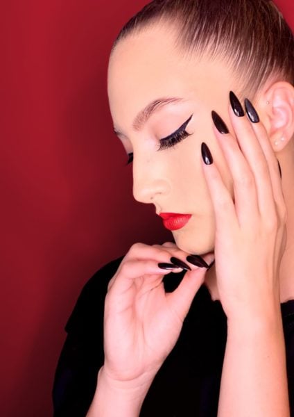 Sara Cady
"“You.” I thought ‘How can I create an image that portrays a personality, an individual?’ I must have done a good job, as when I presented my image to my model (best friend) she said ‘That’s exactly what I thought you’d say! That’s what I think of when I think of you’. So here is my image, the face of my creation. A person close to my heart. Red lip & winged liner, definitely my signature look, beautifully recreated by Briony. Darling, I always wear black. Black nails are my go-to, and here using Black Betty, we have a beautifully simple, yet oh, so classy set. So, as approved by my best friend, my sister, and my husband, my entry for The Great Scratch Shoot Out on the topic: You."