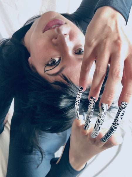 Sarah Murray
"I’m kind of quirky and edgy, but I’m still figuring out who and what I want to be. The hands and toes being joined together gives the sense of feeling trapped and compromised. Something which I am trying to break free of through doing nails. In my free time I train contortion and hand balancing for the circus and shown this through the poses I’ve done.The nail style is inspired by Hattie Stewart as I love really bold and graphic images."