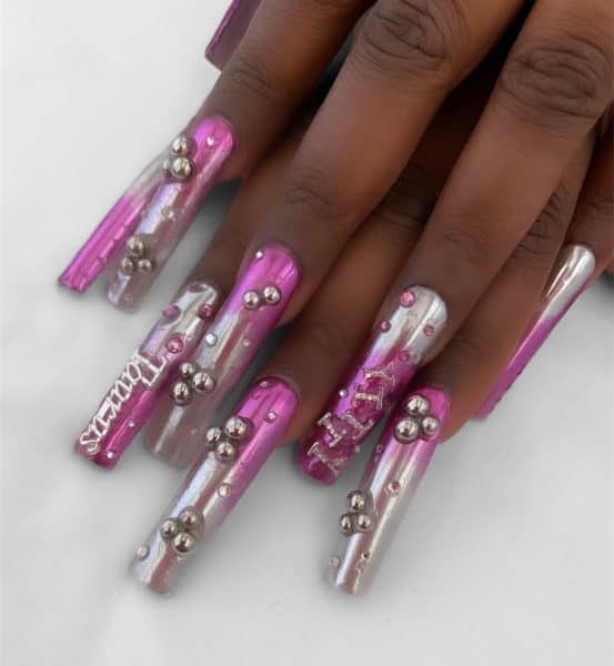 Celebrity nail artist, Eri Ishizu, used CND™ to design this bejewelled pink and silver nail style for singer, Lizzo, featuring the lettering 'Taurus'.