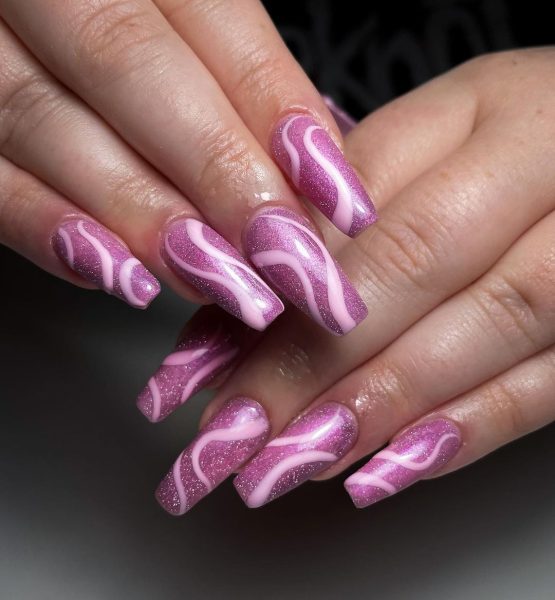 Southampton pro, @trickortreatnails, takes inspiration from @heygreatnails for this swirly elongated style, made standout through a glittering base.