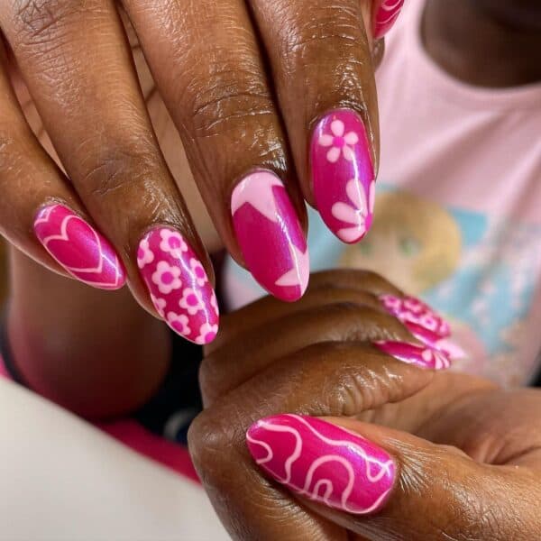 Manchester nail artist, @gels_byash's mix and match design is a visual delight, with heart, floral, star and swirl details.