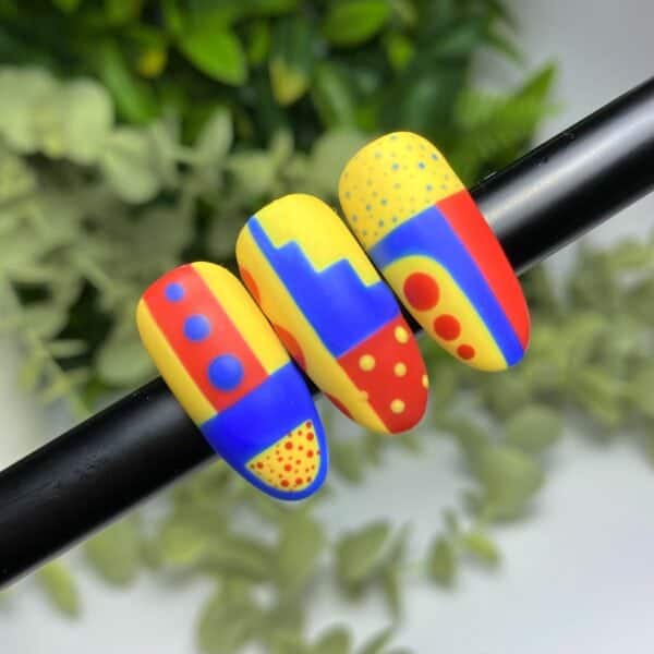 A Geometric Nail Design Created Using Primary Colours